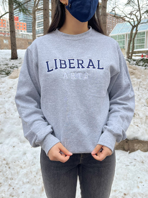 girl wearing a grey liberal arts crewneck